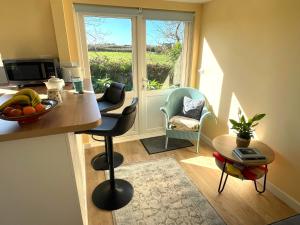 a living room with a table and a window at La Mer self-catering in Sark