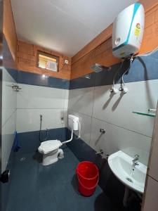 a small bathroom with a toilet and a sink at Alloos homestay villa in Attappādi