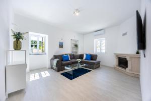 a living room with a couch and a fireplace at Casa do Vale in Paderne