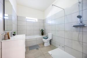 a white bathroom with a toilet and a sink at Casa do Vale in Paderne +22 photos