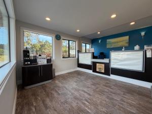 a large room with blue walls and wooden floors and windows at Fisherman's Cove Inn in Monterey