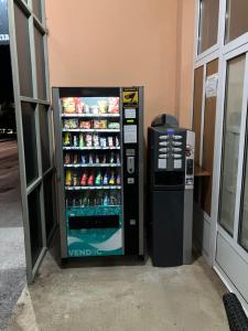 a vending machine is next to a drink cooler at Apartments & Rooms CASA GAGRO in Međugorje