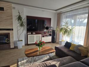 a living room with a couch and a table at Białowieski Raj in Białowieża