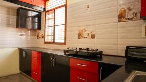 a kitchen with a stove top on a counter at DUDI's Stay in Mysore