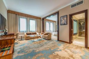 a living room with a couch and a table at Madareem Hotel in Riyadh