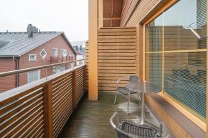 a balcony with a table and chairs on it at City Centre Apartment Levi in Sirkka