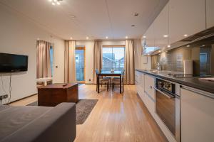 a kitchen with a table and a dining room at City Centre Apartment Levi in Sirkka