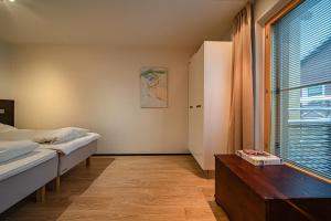 a bedroom with a bed and a table and a window at City Centre Apartment Levi in Sirkka