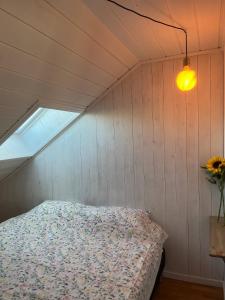 a bedroom with a bed in a room with a window at Penthouse in Farsund in Farsund
