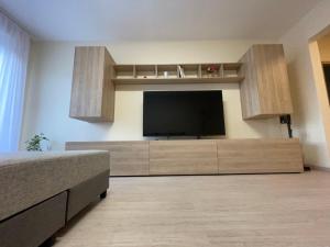 a living room with a flat screen tv on a wall at Kodó Apartman in Székesfehérvár