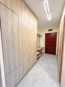 a hallway with wood paneled walls and a door at Kodó Apartman in Székesfehérvár