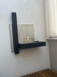 a candle in a glass bowl on a wall at Suite con jacuzzi in pieno centro in Benevento