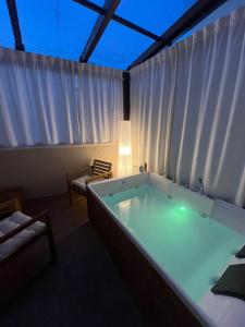 a large bath tub in the middle of a room at Suite con jacuzzi in pieno centro in Benevento