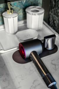 a bathroom counter with a hair dryer and two candles at Zishui Qinglu Manor in Sanya