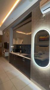 a kitchen with a sink and a mirror on a wall at Aayu's Home 74 in Noida +3 photos