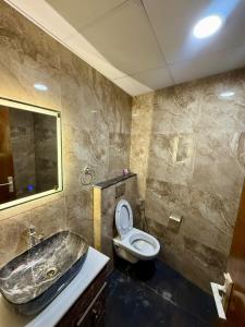a bathroom with a sink and a toilet at Aayu's Home 74 in Noida