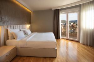 a bedroom with a large bed and a large window at Hotel Jana in Međugorje +33 photos