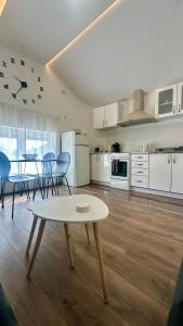 a kitchen and dining room with a table and chairs at Lane Stay Studio in Beograd