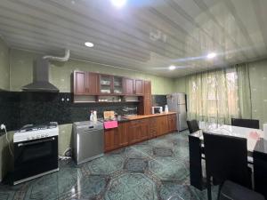 a kitchen with wooden cabinets and a stove top oven at Marikuna in Gori