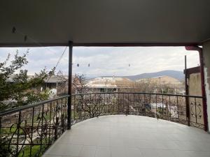 a balcony with a view of a city at Marikuna in Gori +3 photos
