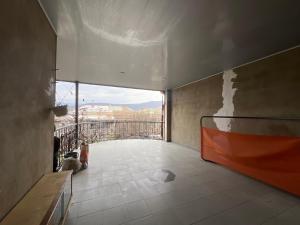 a room with a balcony with a view of a city at Marikuna in Gori