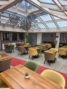 an empty restaurant with wooden tables and chairs at Brauerei Walter in Waldshut-Tiengen