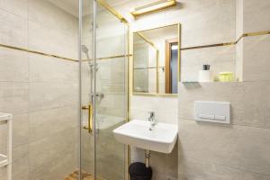 a bathroom with a sink and a shower at Sanatorium Zefir in Krynica Morska +77 photos