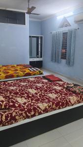two beds on display in a room at Avani homestay in Subrahmanya