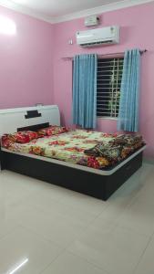 a bedroom with a bed in a pink room at Avani homestay in Subrahmanya