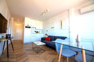 a living room with a blue couch and a table at panoramic boutique con preciosas vistas in Benalmádena +18 photos