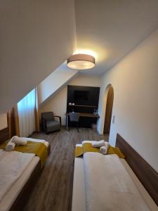 a hotel room with two beds and a flat screen tv at Brauerei Walter in Waldshut-Tiengen