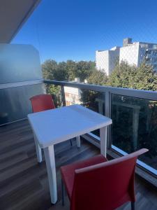a white table and two chairs on a balcony at La Raquel in La Plata