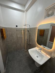 a bathroom with a sink and a shower at Flower Resort Ella in Ella +19 photos