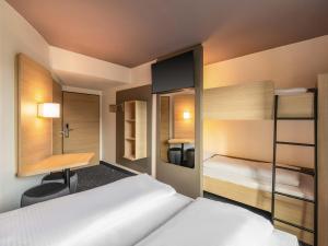 a bedroom with two bunk beds and a desk at B&B Hotel Düsseldorf-City in Düsseldorf +21 photos