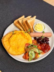 a plate of breakfast food with a fried egg and toast at Готель Гоголь in Poltava