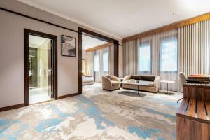 a living room with a couch and a table at Madareem Hotel in Riyadh