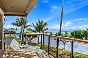 a balcony with chairs and a view of the ocean at Puunoa Beach Estates 205 in Lahaina