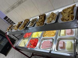 a display case filled with lots of different types of food at HOTELSÃORAFAEl in Água Boa