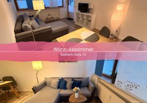 a living room with a couch and a table at Ferienwohnung Karrasch in Schwangau