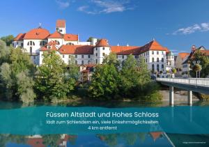 a group of buildings with a bridge and water at Ferienwohnung Karrasch in Schwangau