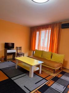 a living room with a couch and a table at Gelov Hotel in Berkovitsa