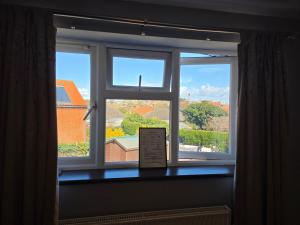a window with a view of a building at Mount Lavinia in Sheringham +34 photos