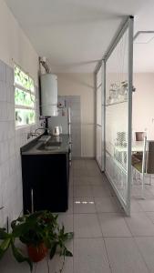 a kitchen with a sink and a stove at La casita in Río Cuarto