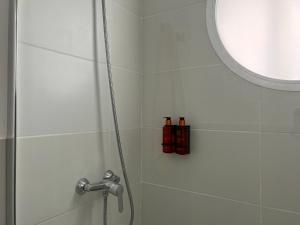 a shower with two shampoo bottles in a bathroom at Canaryislandshost l Balcón del Mar in Puerto del Carmen +18 photos