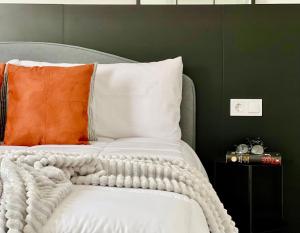 a bed with an orange and white blanket on it at Canaryislandshost l Balcón del Mar in Puerto del Carmen