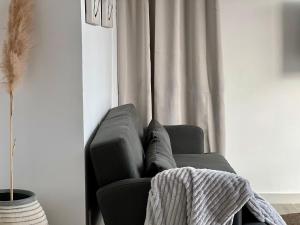 a couch with a blanket on it in a living room at Canaryislandshost l Balcón del Mar in Puerto del Carmen