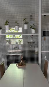 a kitchen with a table with chairs and potted plants at La casita in Río Cuarto