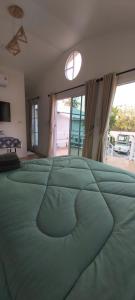 a large green bed in a bedroom with a window at วันรีสอร์ท in Ratchaburi