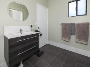 a bathroom with a sink and a mirror at The French River Chalets in Kalgan +39 photos