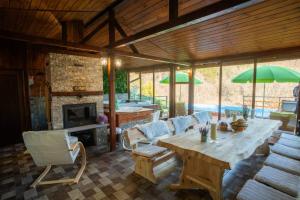 a large living room with a wooden table and chairs at Green View 2 in Skrino